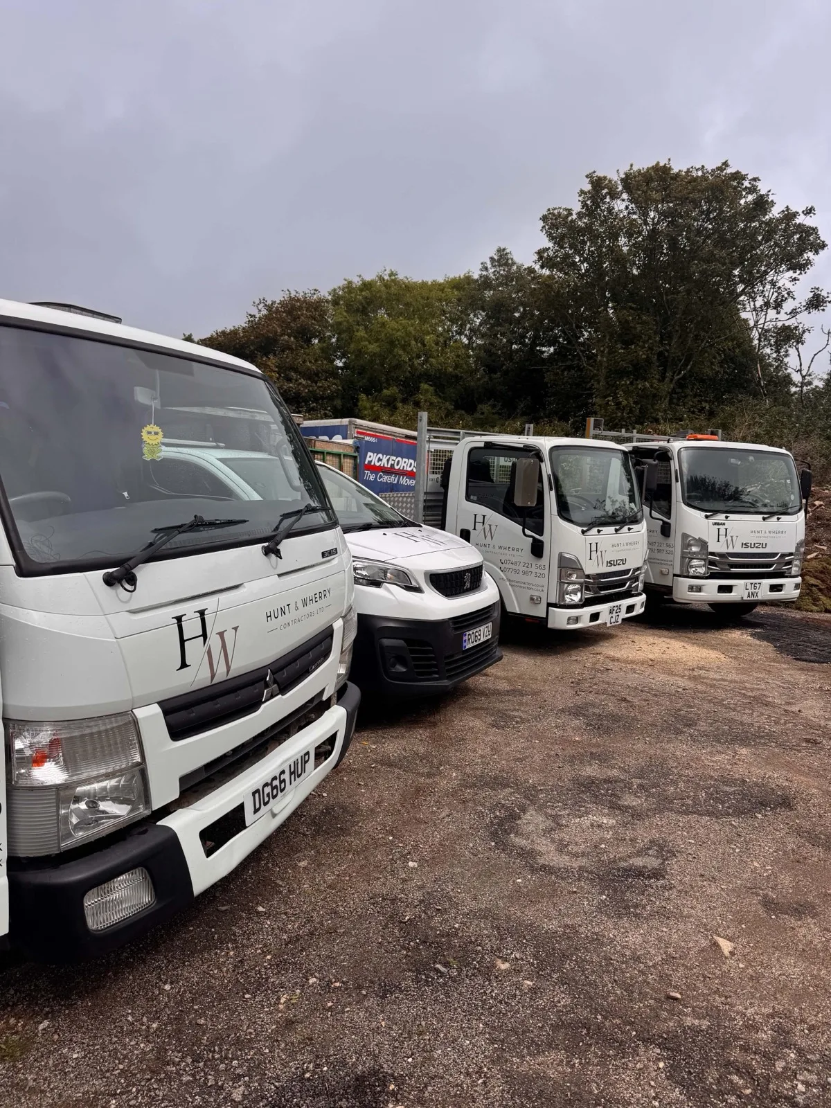 The liveried Mitsubishi Canter tipper at the front of the HW Contractors fleet, with the van and two Isuzu tippers behind
