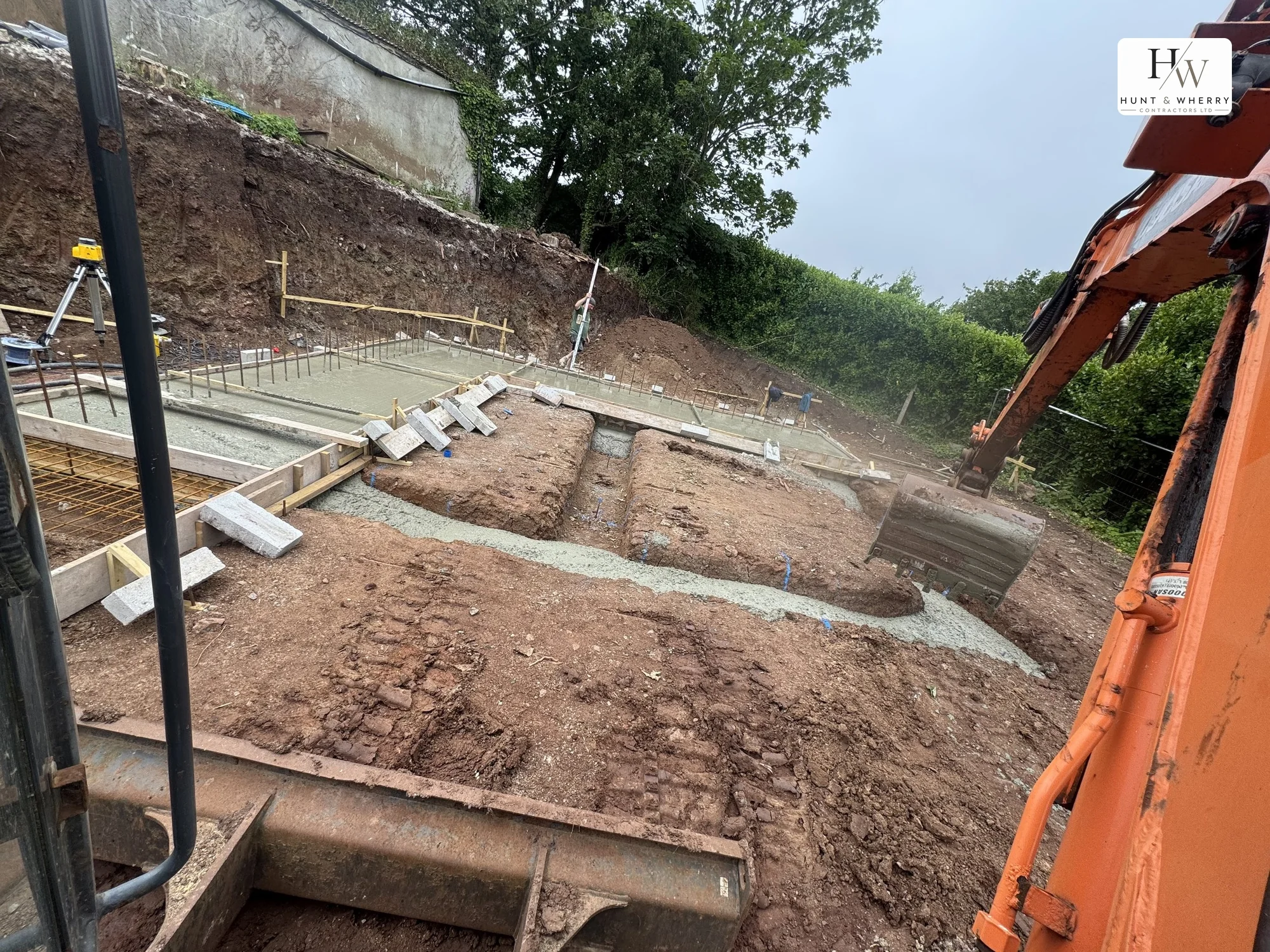 Reinforced raft foundation with rebar mesh, timber shuttering and poured strip footings on a Cornish site