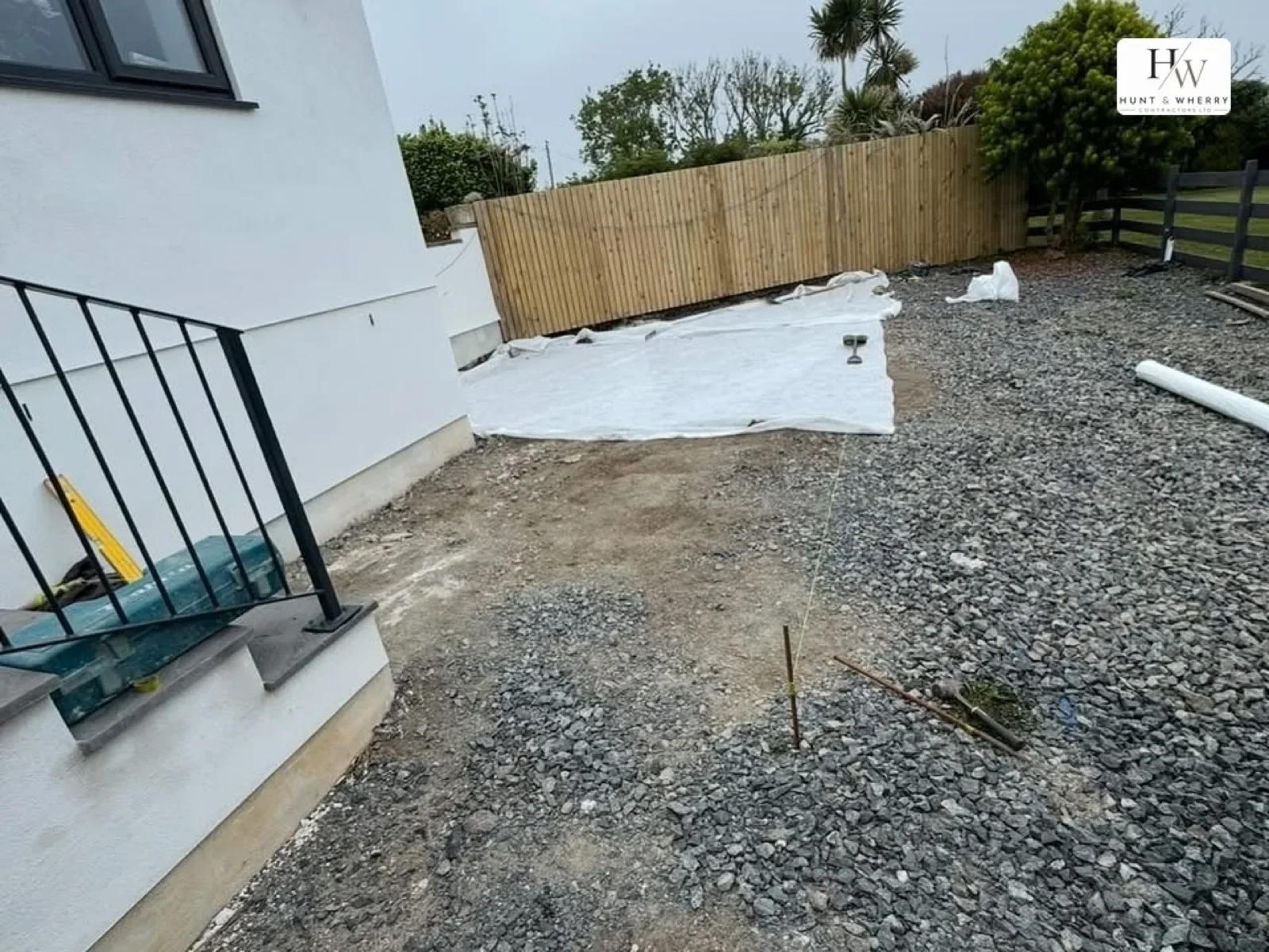 Groundworks in progress with sub-base and membrane at a house corner