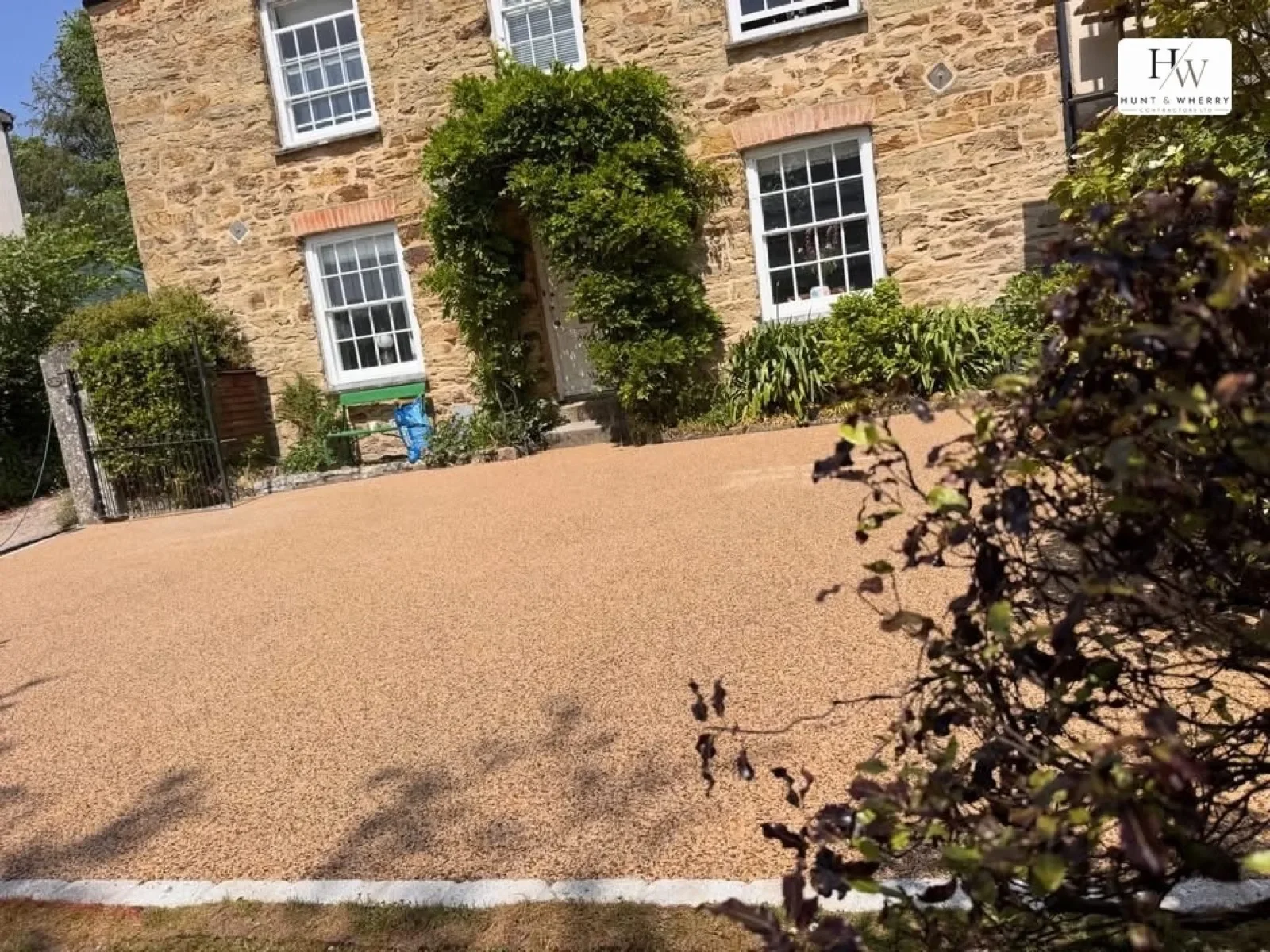 Golden resin bound driveway outside a Cornish stone cottage