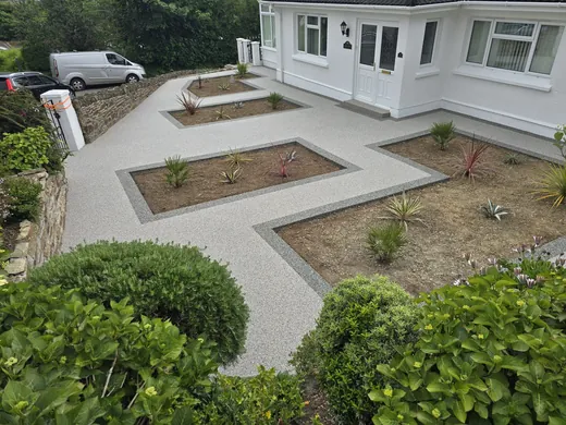 Silver resin bound front garden with charcoal edged planting beds