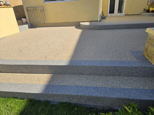 Silver resin bound patio with a charcoal banded step